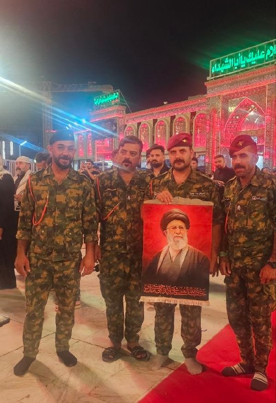 Image of Ayatollah Ali Khamenei Held by Iraqi Military Personnel